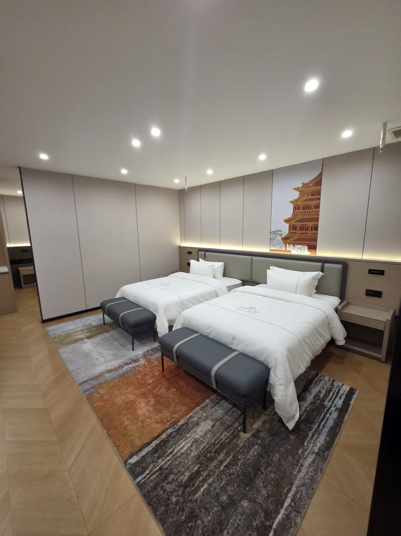 Twin guest-room furnishing example supplied by a manufacturing partner